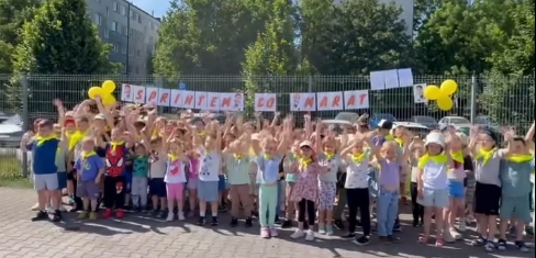Wszystkie dzieci stoją na tle napisu sprintem do maratonu.